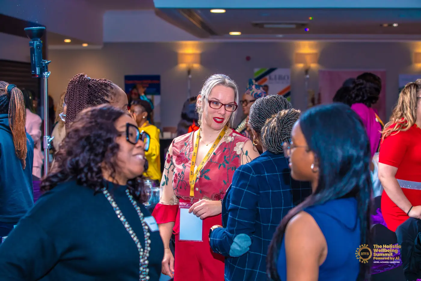 Women talking in small groups between sessions at the Holistic Wellbeing Summit.